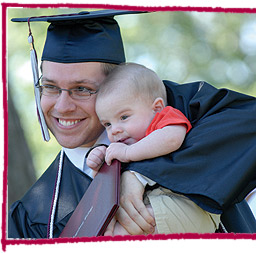 Picture of graduate holding a baby
