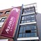 Maroon Augsburg banner against a tall glass window